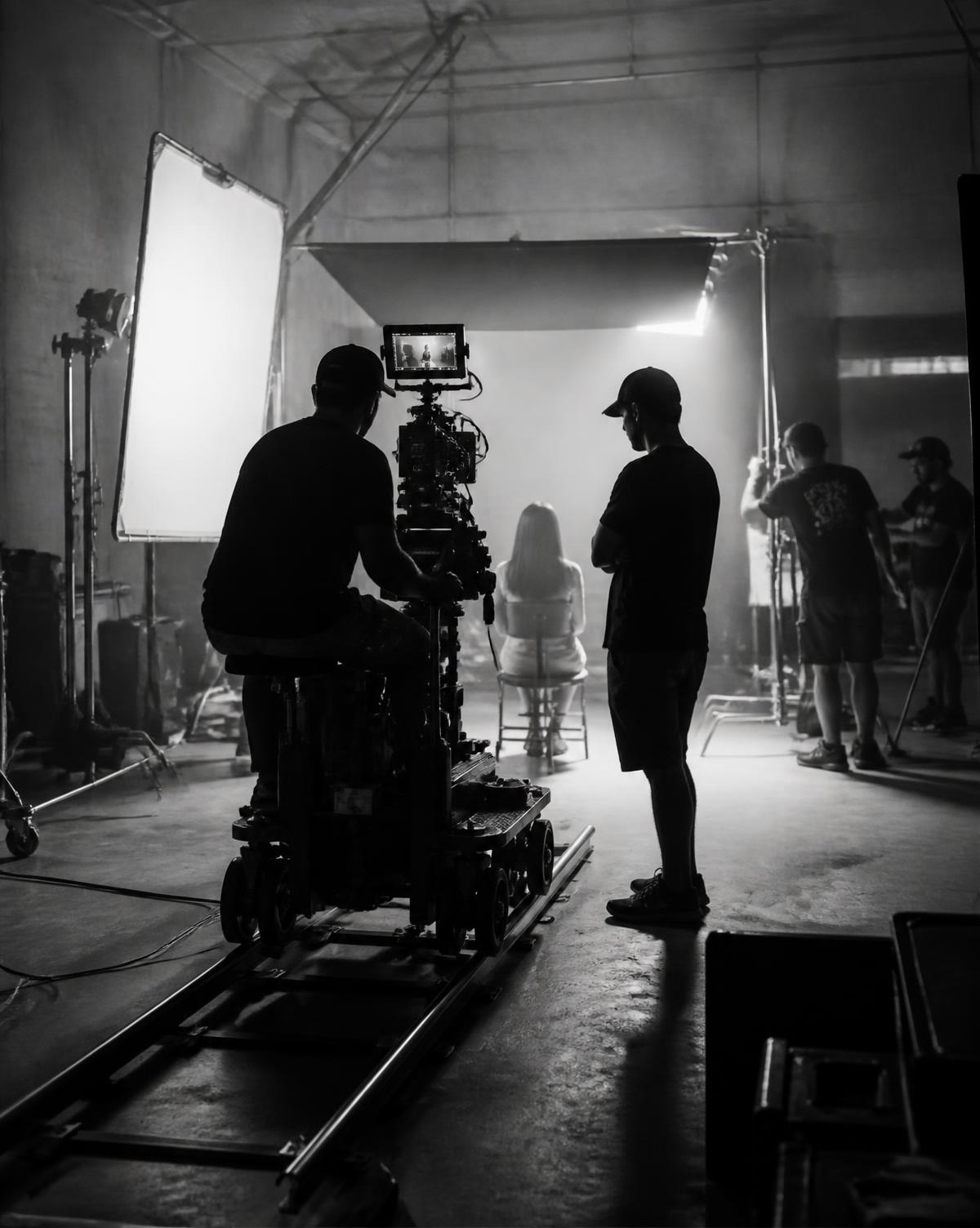 Film crew operating a cinema camera on a studio set